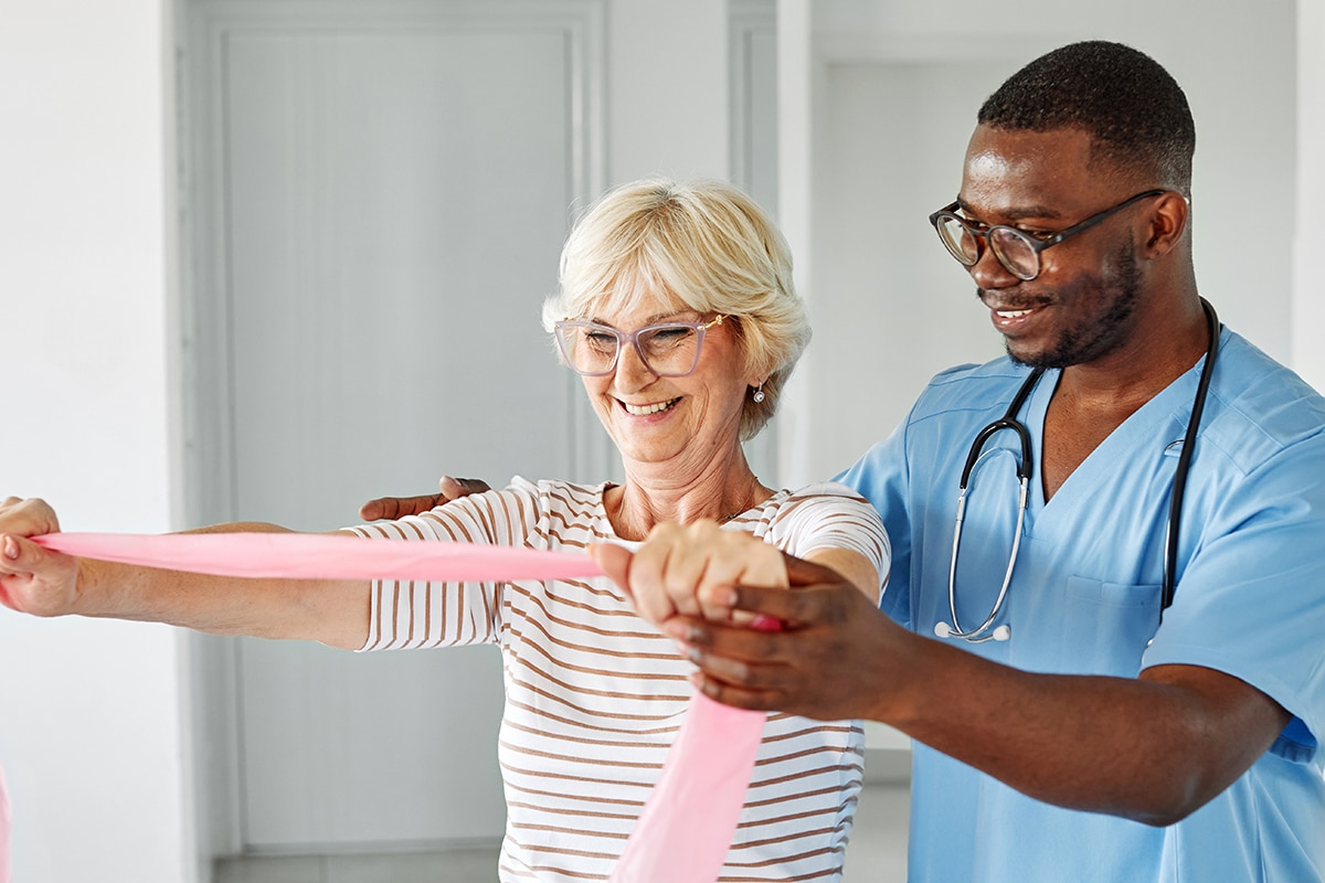 therapist and senior woman exercising